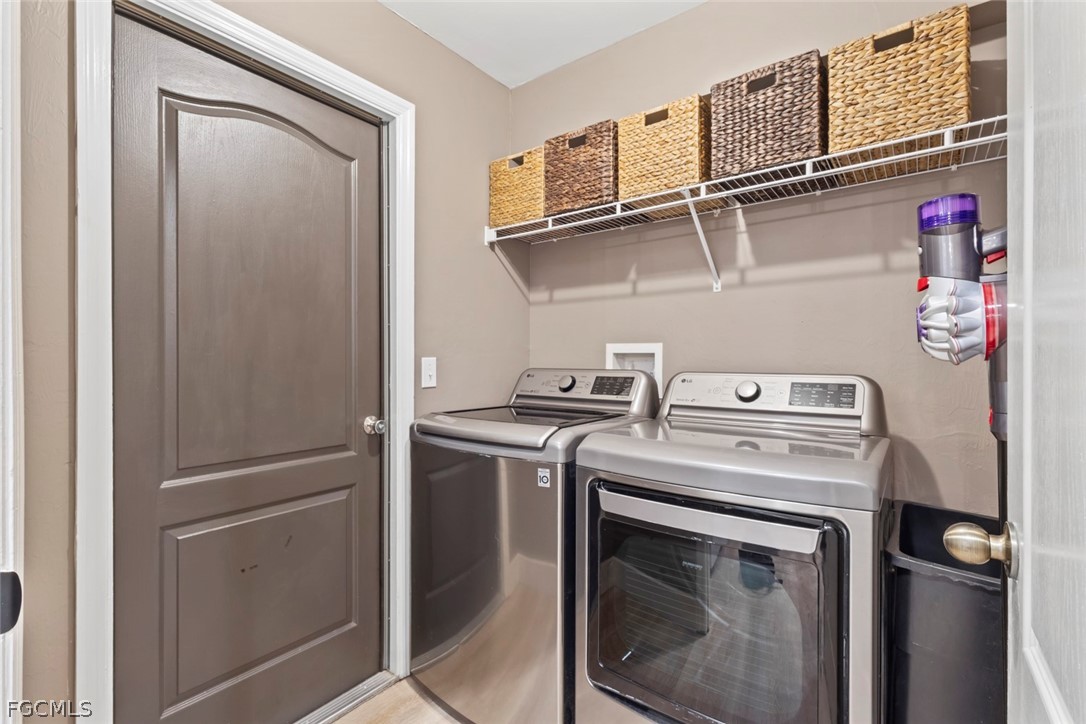 3610 65th Street West Lehigh Acres, FL 33971 - Photo 23 of 33 a close up of a washer and dryer