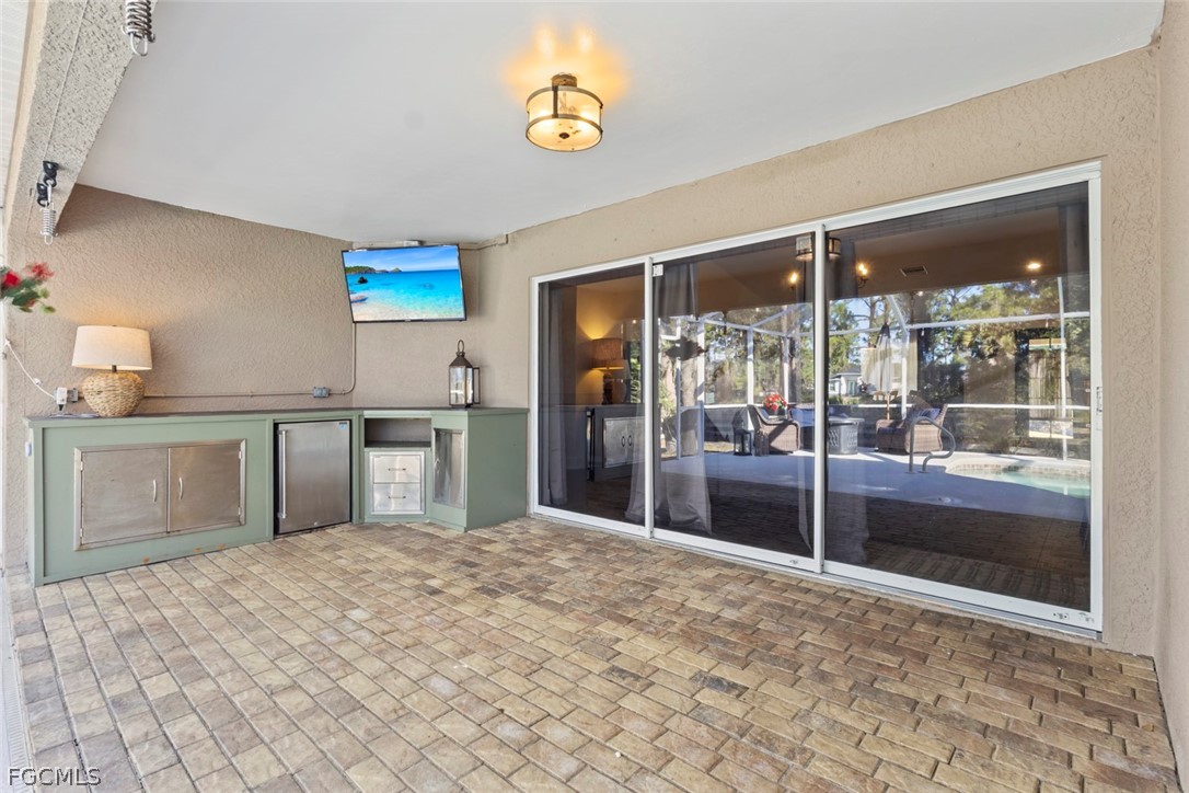3610 65th Street West Lehigh Acres, FL 33971 - Photo 24 of 33 a kitchen with stainless steel appliances granite countertop a refrigerator and a sink