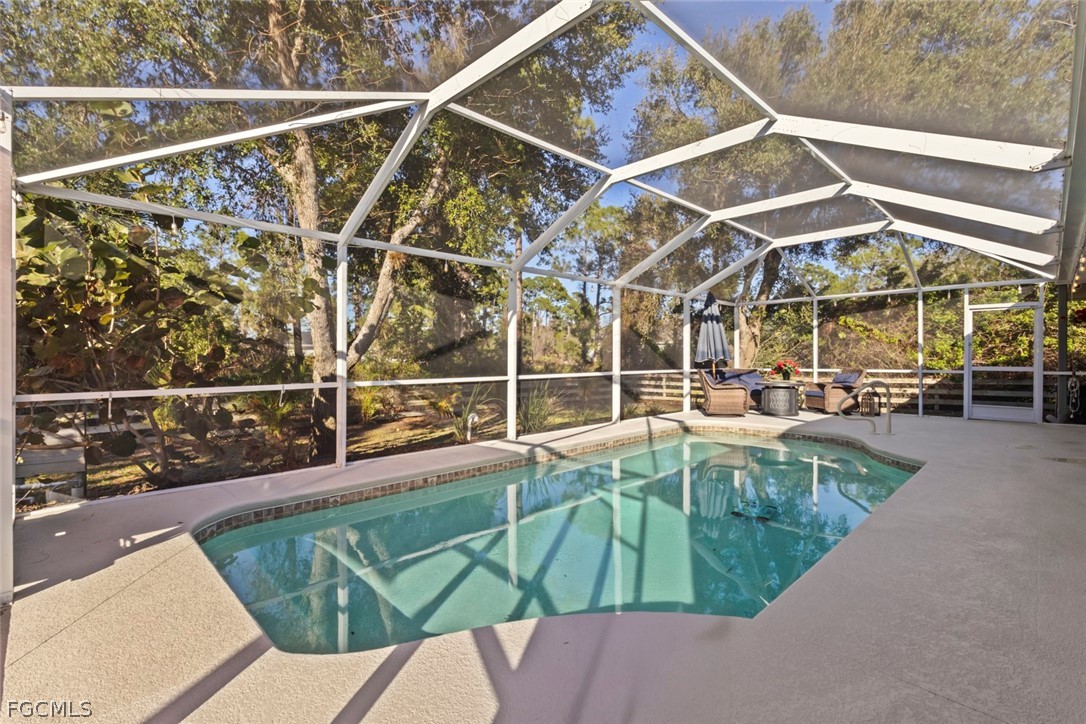3610 65th Street West Lehigh Acres, FL 33971 - Photo 27 of 33 a view of a swimming pool with a patio and plants