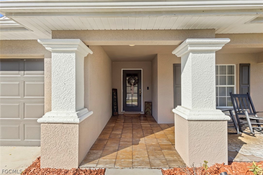 3610 65th Street West Lehigh Acres, FL 33971 - Photo 3 of 33 a view of a hallway with a dining table and chairs