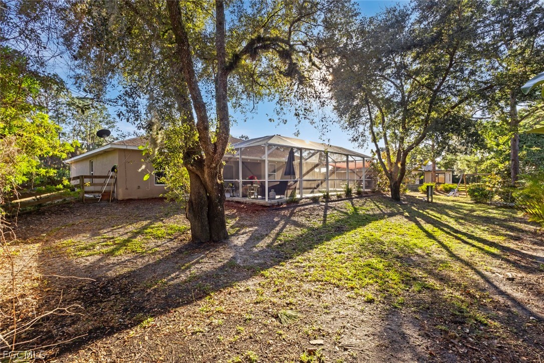 3610 65th Street West Lehigh Acres, FL 33971 - Photo 31 of 33 a view of a swimming pool with an outdoor seating and a yard