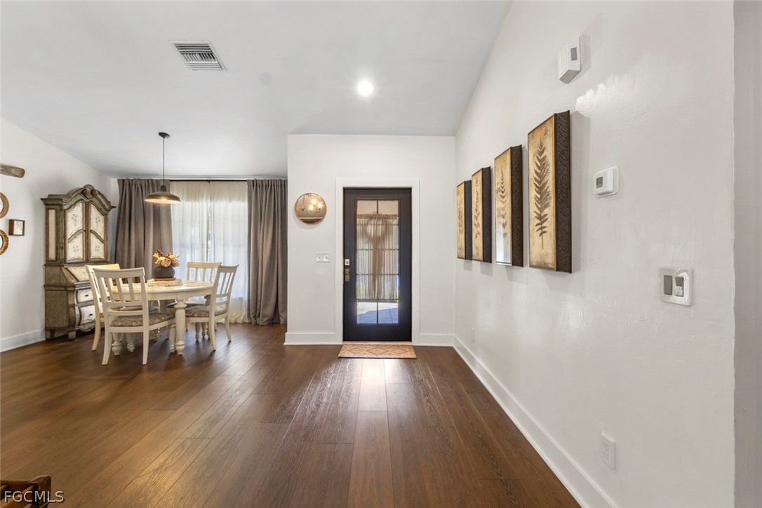 3610 65th Street West Lehigh Acres, FL 33971 - Photo 5 of 33 a view of a dining room with furniture and wooden floor