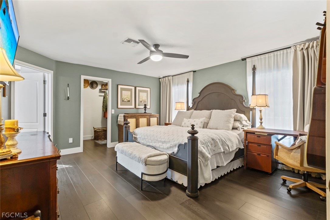 3610 65th Street West Lehigh Acres, FL 33971 - Photo 10 of 33 a bedroom with a bed and wooden floor