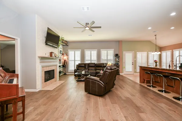 a living room with furniture fireplace and flat screen tv