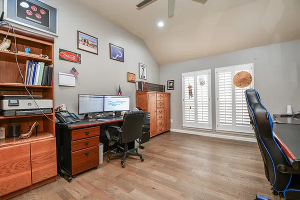 a view of workspace with lounge chair and windows