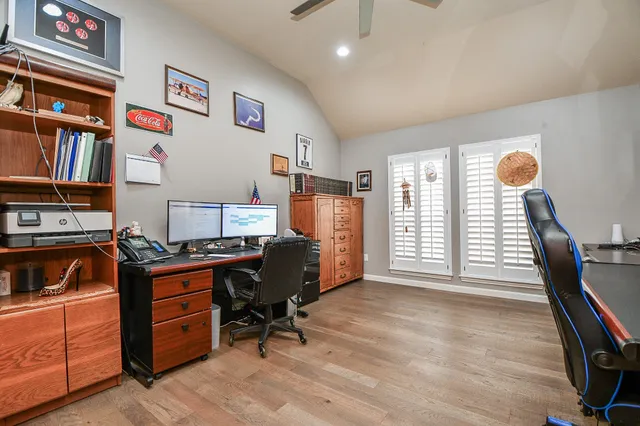 a view of workspace with lounge chair and windows