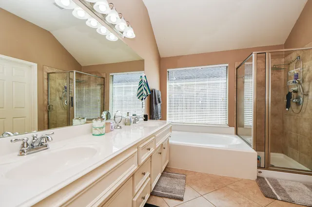a spacious bathroom with sinks mirror and a bath tub