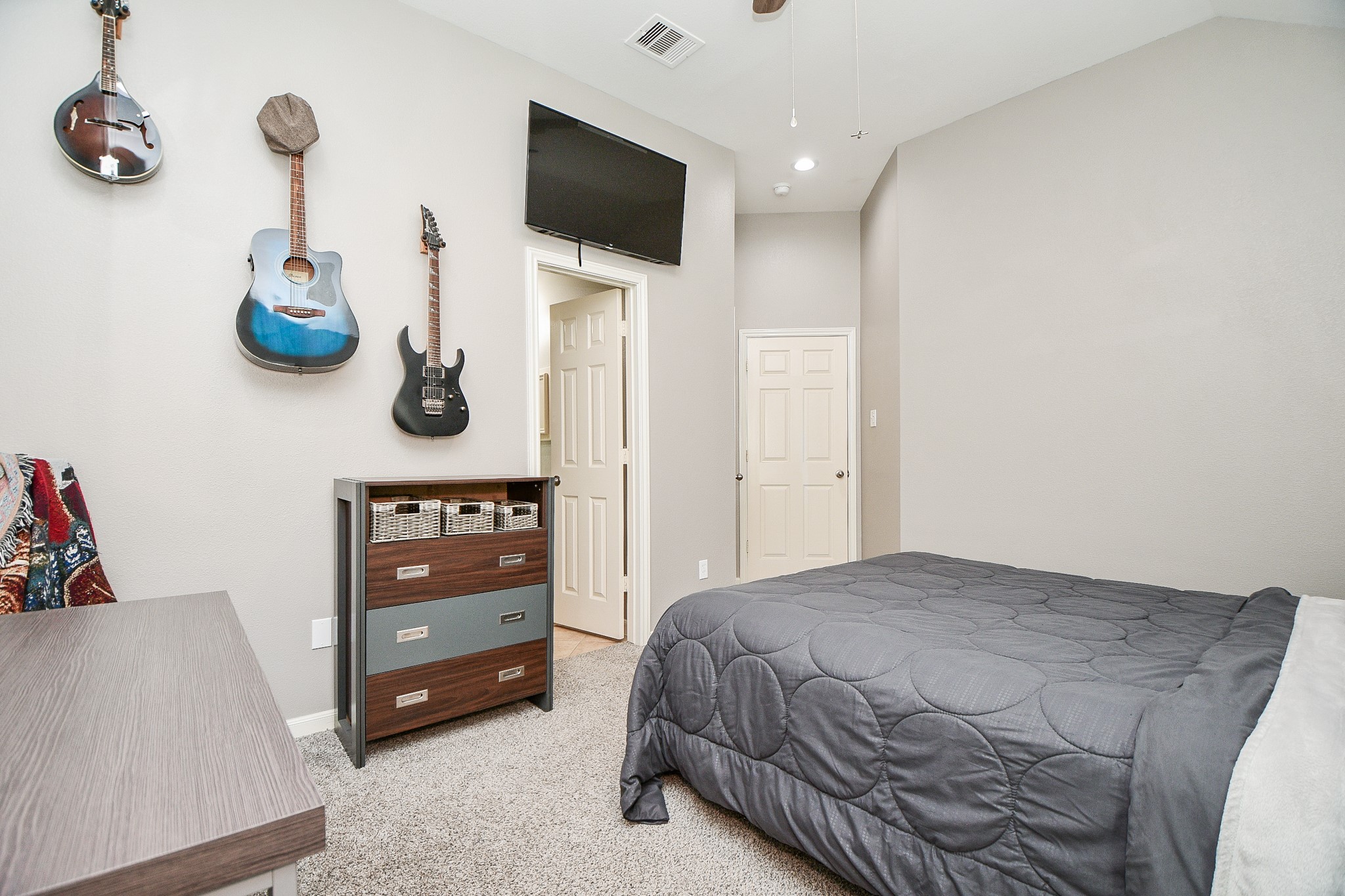 5324 Troutline Lane Rosenberg, TX 77471 - Photo 26 of 30 a bedroom with a bed and a flat tv screen on dresser