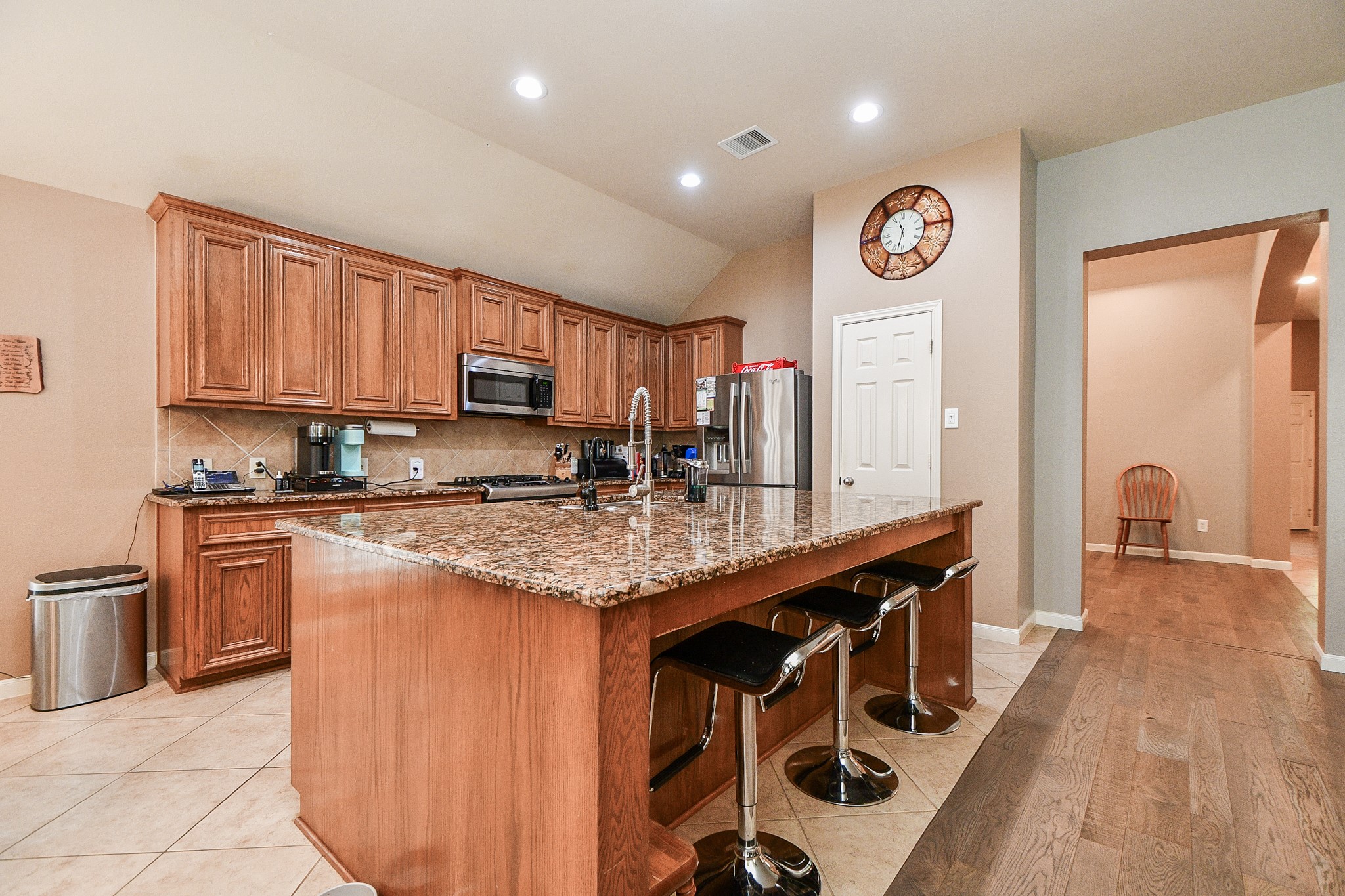 5324 Troutline Lane Rosenberg, TX 77471 - Photo 7 of 30 a kitchen with granite countertop a stove a sink and a refrigerator