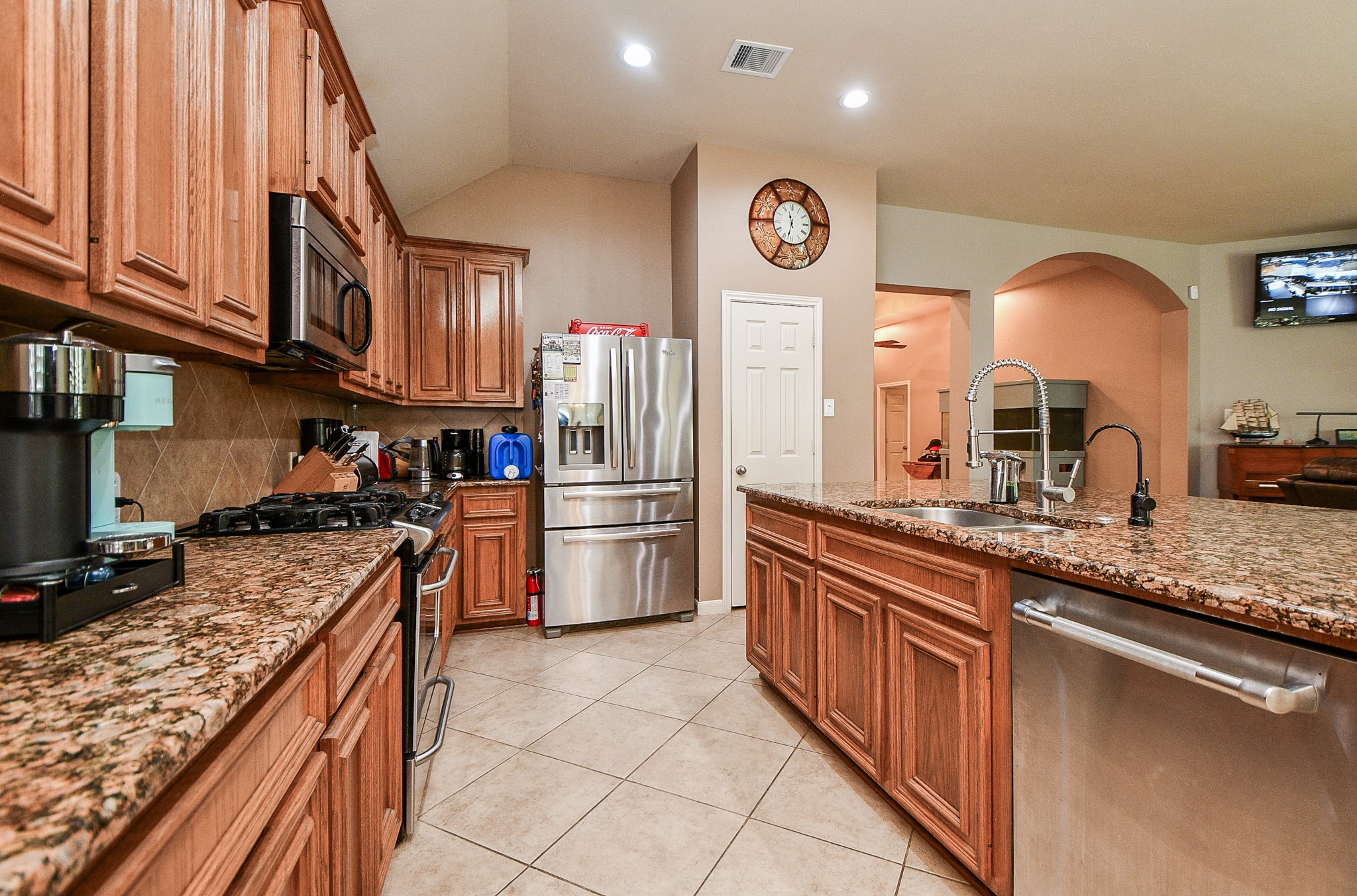 5324 Troutline Lane Rosenberg, TX 77471 - Photo 9 of 30 a kitchen with stainless steel appliances granite countertop a stove a sink and a refrigerator