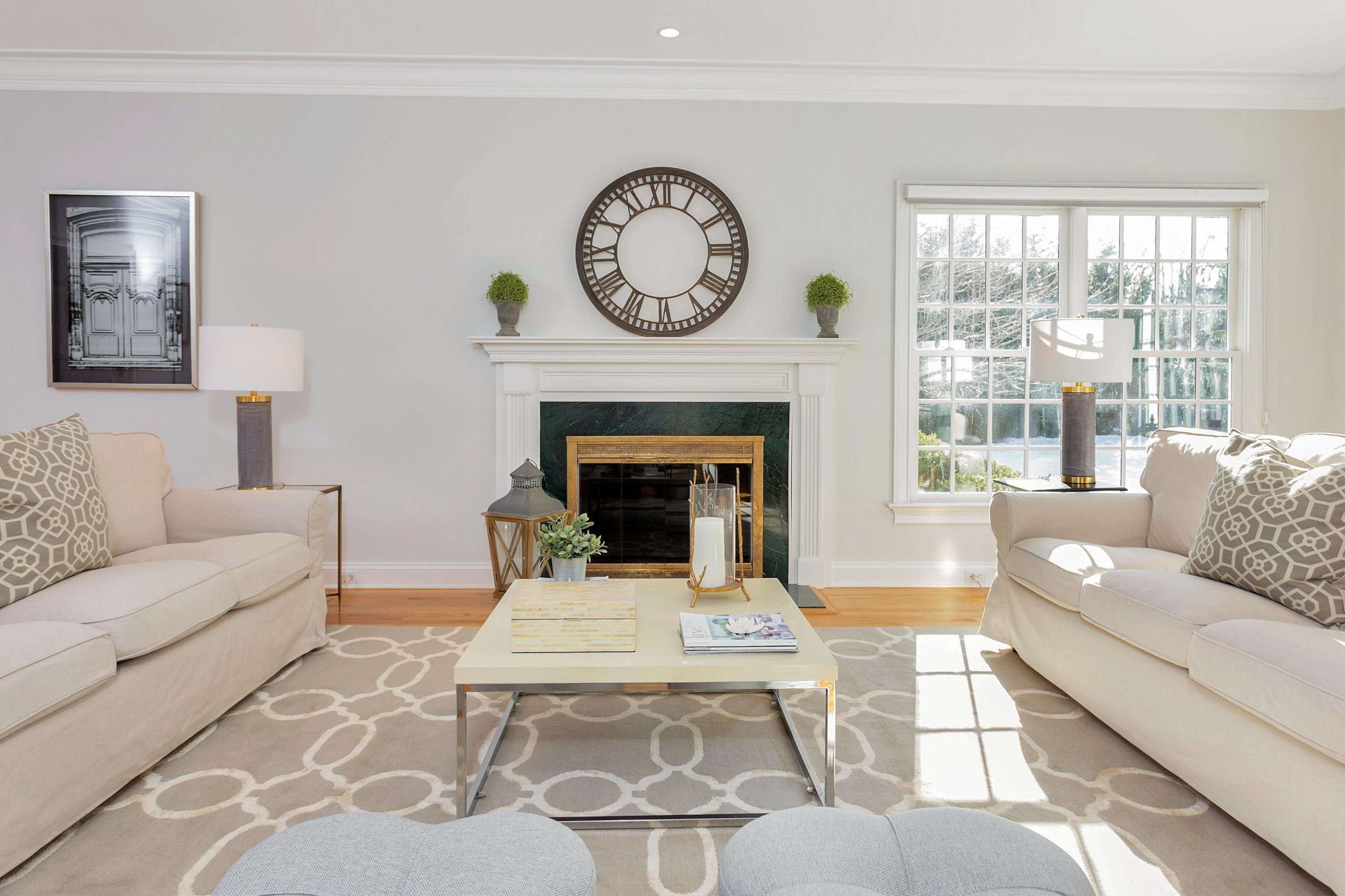 244 Hollow Tree Ridge Road Darien, CT 06820 - Photo 7 of 38 a living room with furniture a clock and a large window
