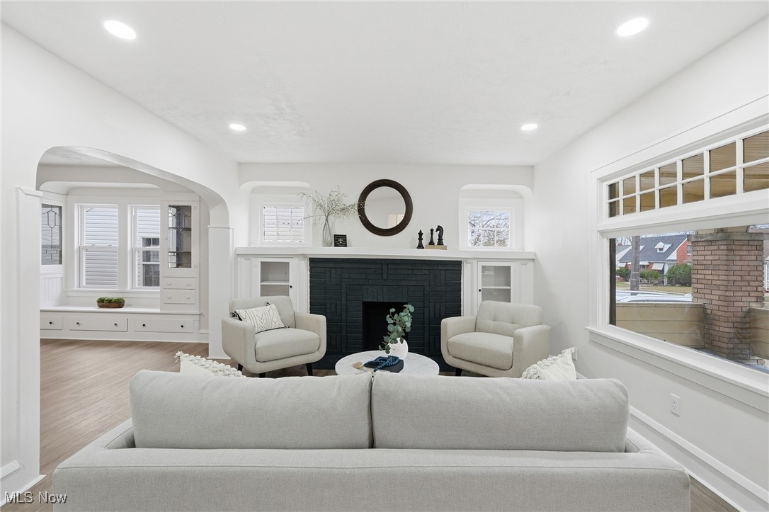 7911 Snow Road Parma, OH 44129 - Photo 6 of 44 Living room with a fireplace, wood finished floors, recessed lighting, and arched walkways