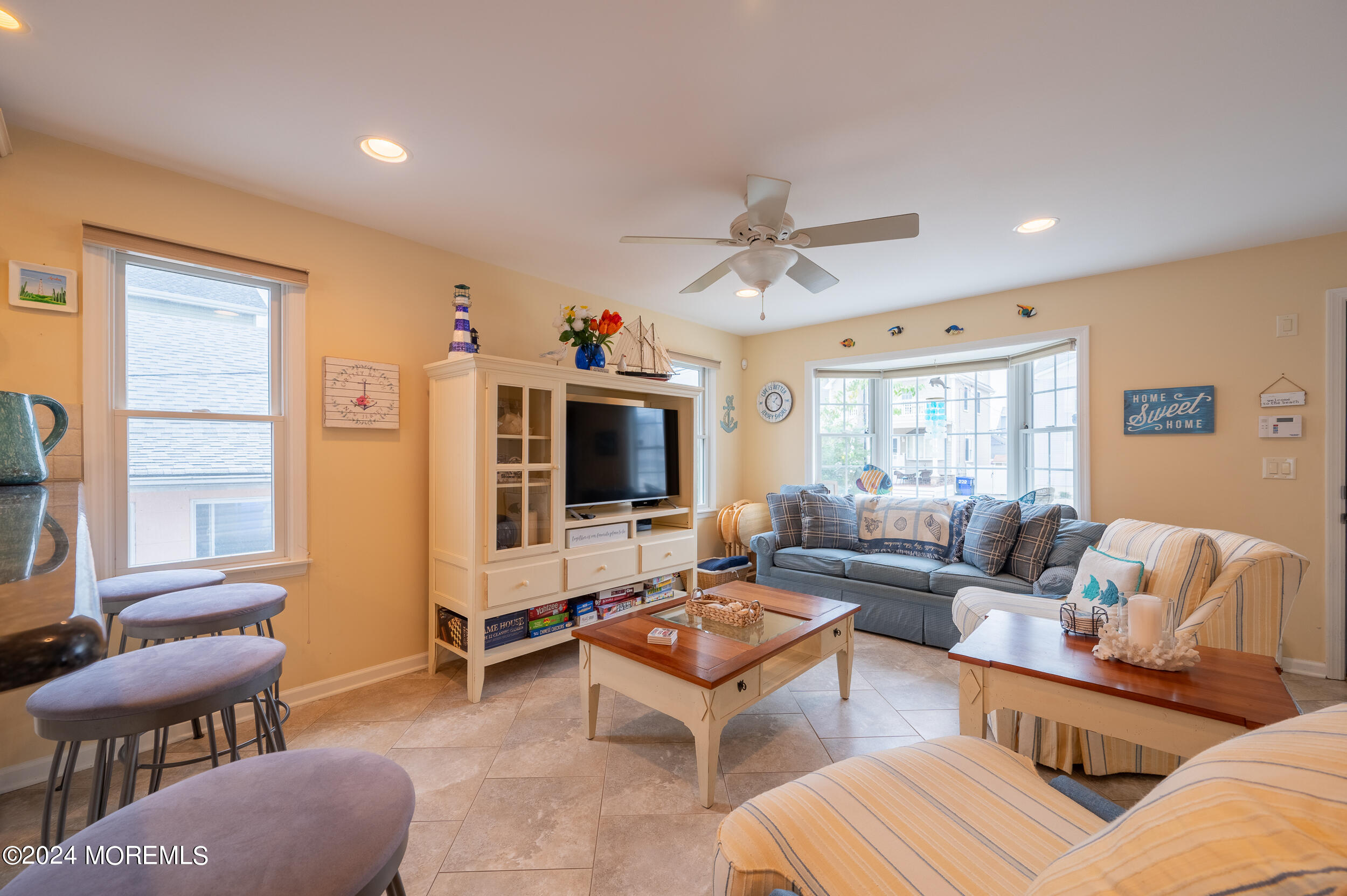219 3rd Avenue Seaside Heights, NJ 08751 - Photo 12 of 27 a living room with furniture a flat screen tv and a window