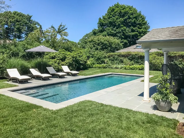 a view of a house with yard and sitting area