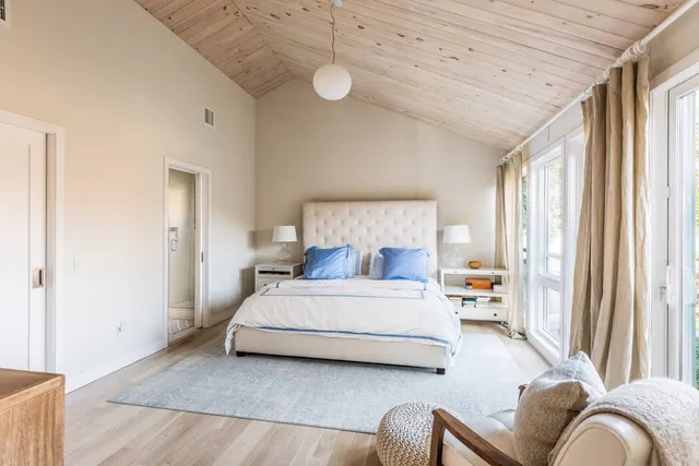 a bedroom with a bed couch and window