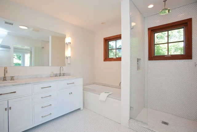 a bathroom with a granite countertop sink a toilet and shower