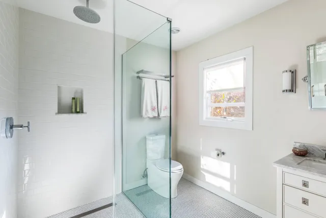 a bathroom with a toilet sink and shower