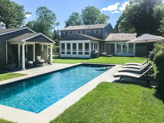 a front view of a house with a yard table and chairs