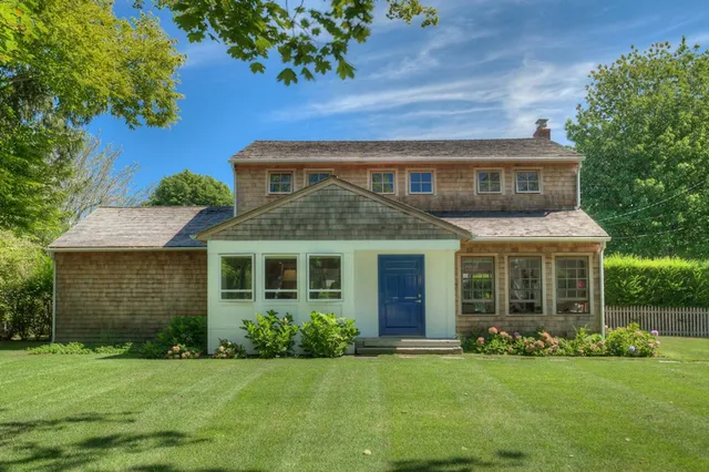 a front view of a house with a garden
