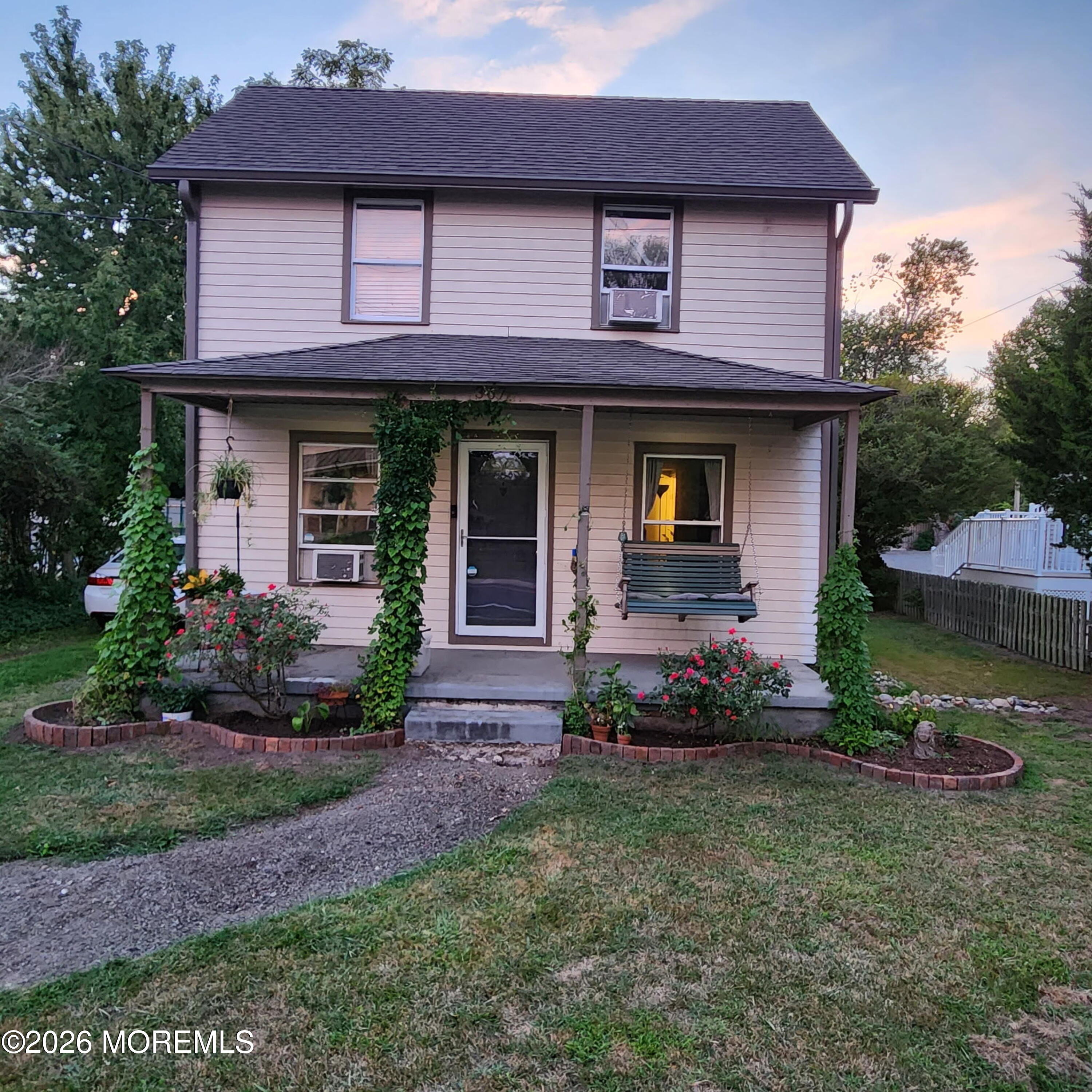 a front view of a house with a garden