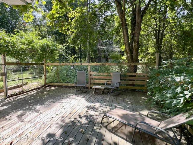 a backyard of a house with lots of green space and fountain in the back