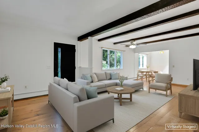 a view of a big room with windows and chandelier fan