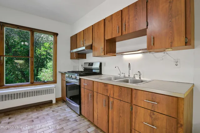 a kitchen with stainless steel appliances granite countertop a sink stove and cabinets