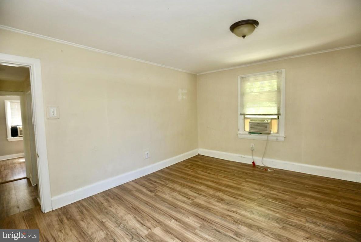 310 Ellis Street Glassboro, NJ 08028 - Photo 8 of 15 an empty room with wooden floor and windows