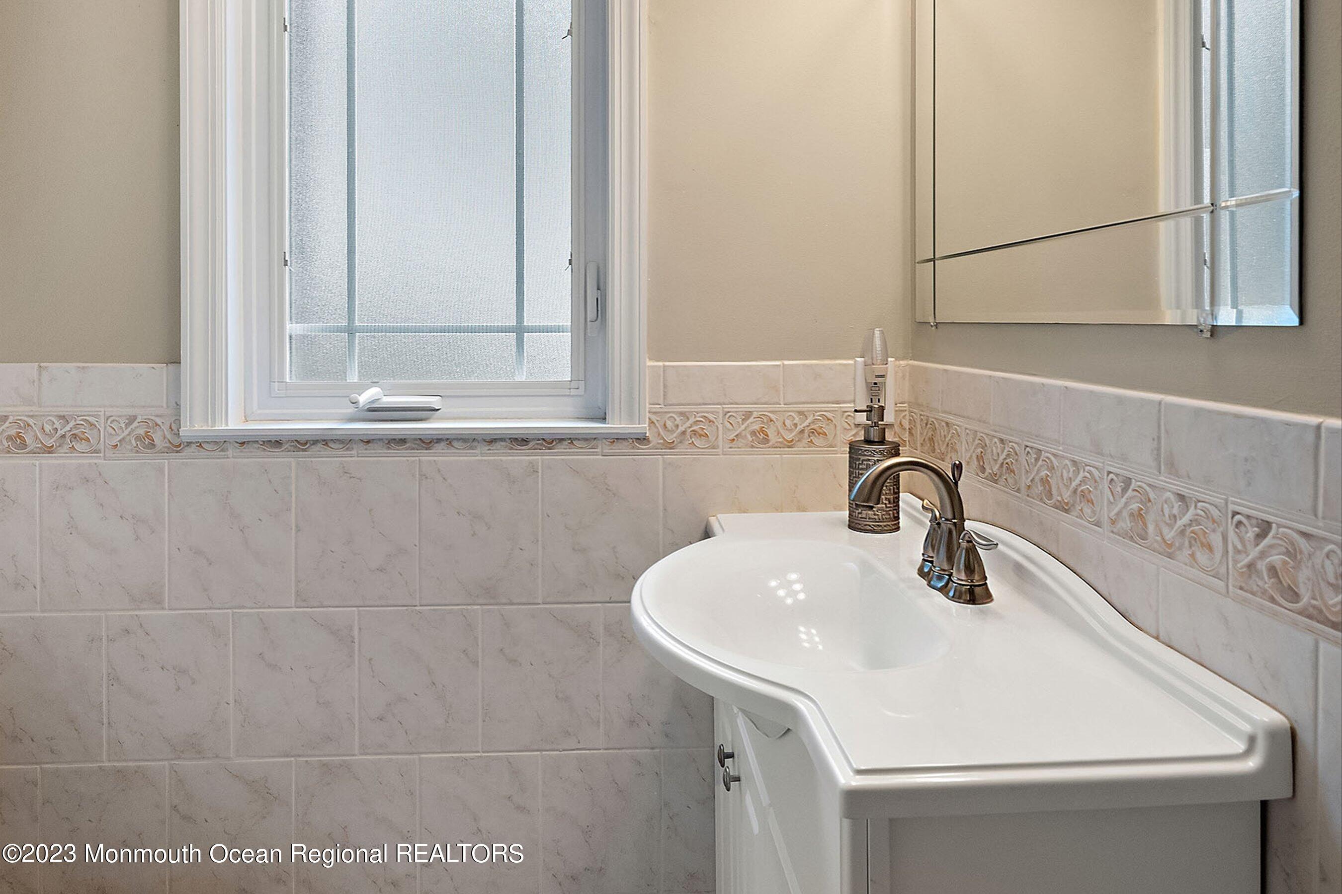 554 Hopping Road Belford, NJ 07718 - Photo 16 of 26 a bathroom with a sink and a mirror