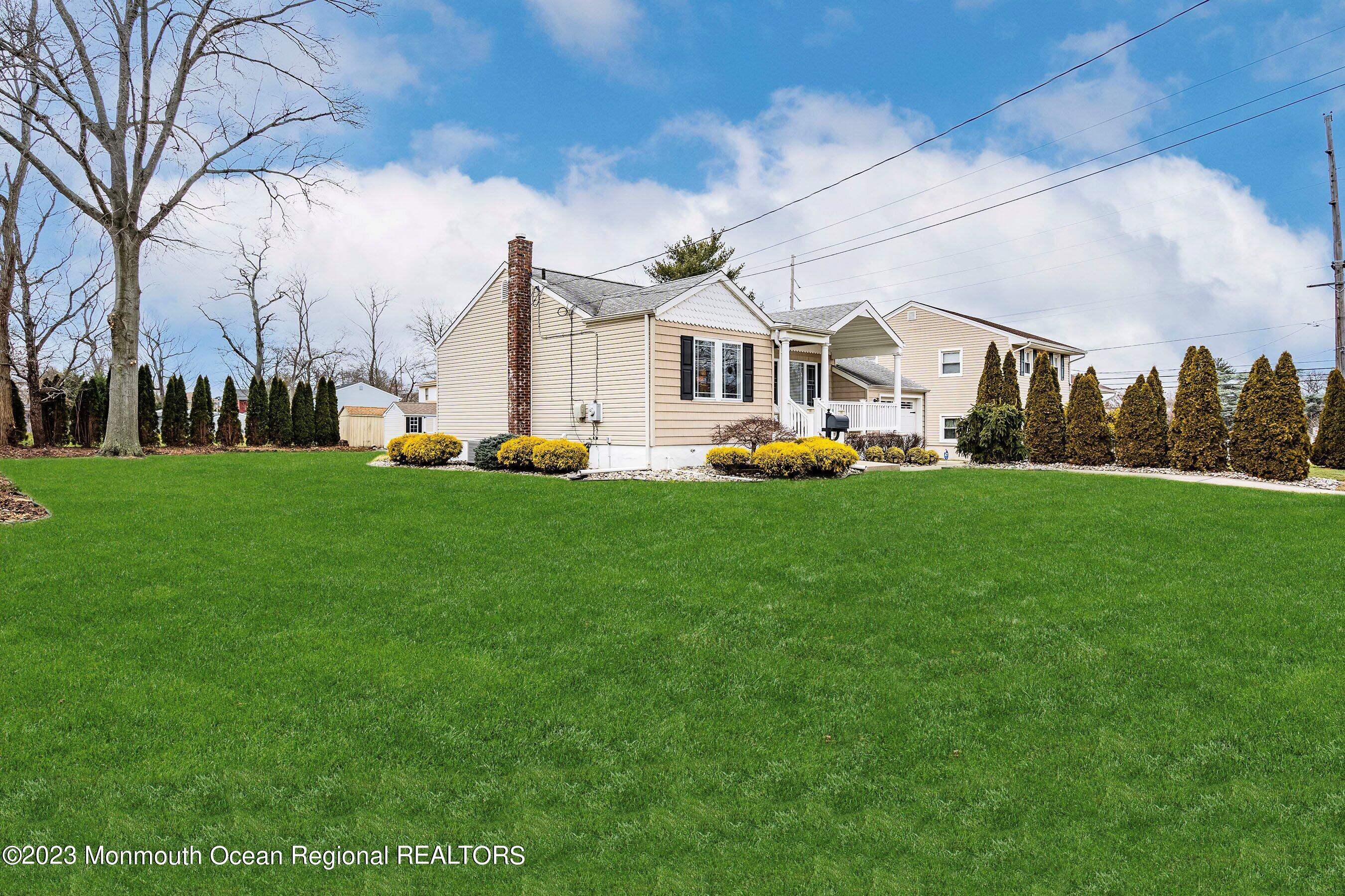 554 Hopping Road Belford, NJ 07718 - Photo 3 of 26 a view of a town with large trees and plants