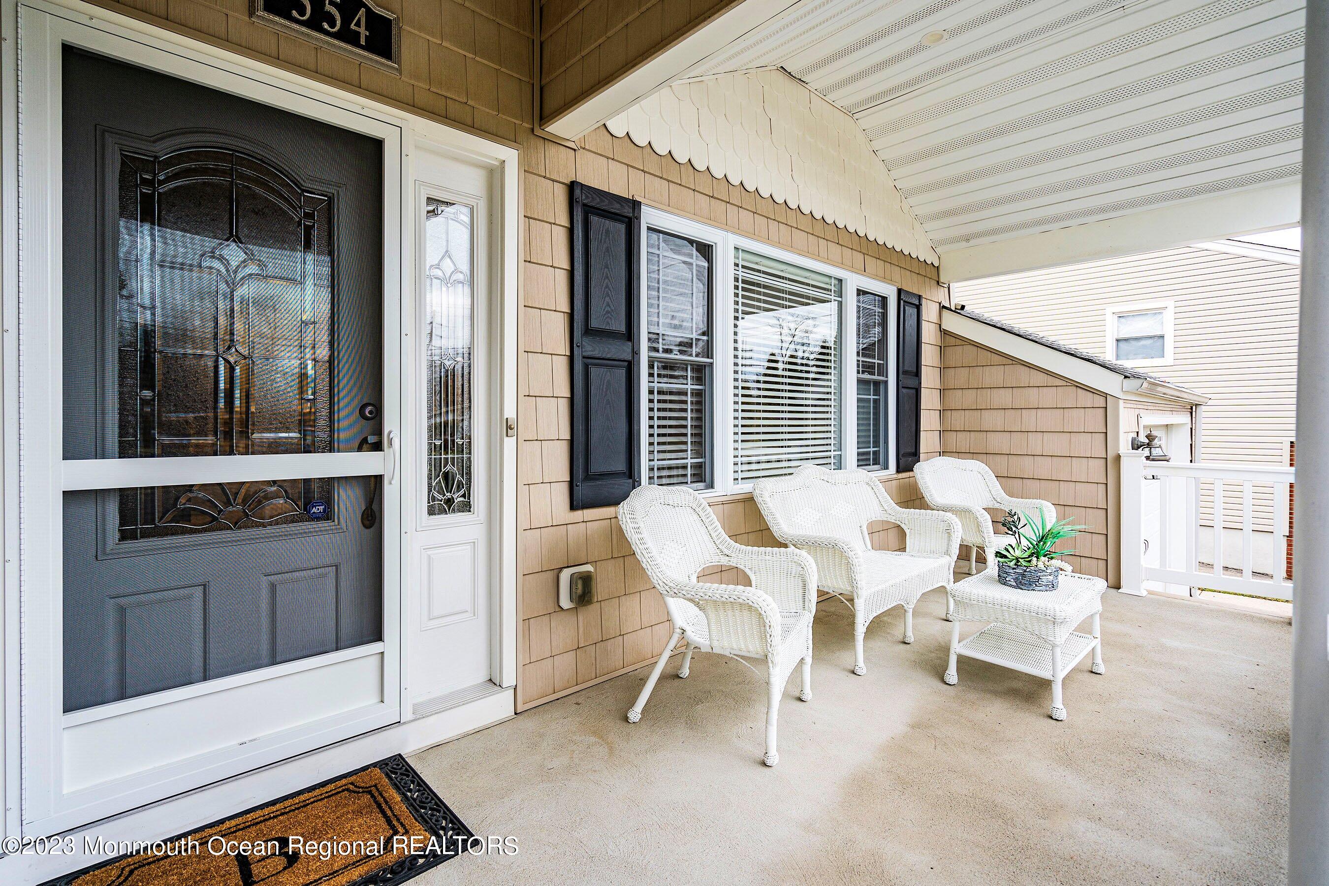 554 Hopping Road Belford, NJ 07718 - Photo 4 of 26 a balcony with table and chairs