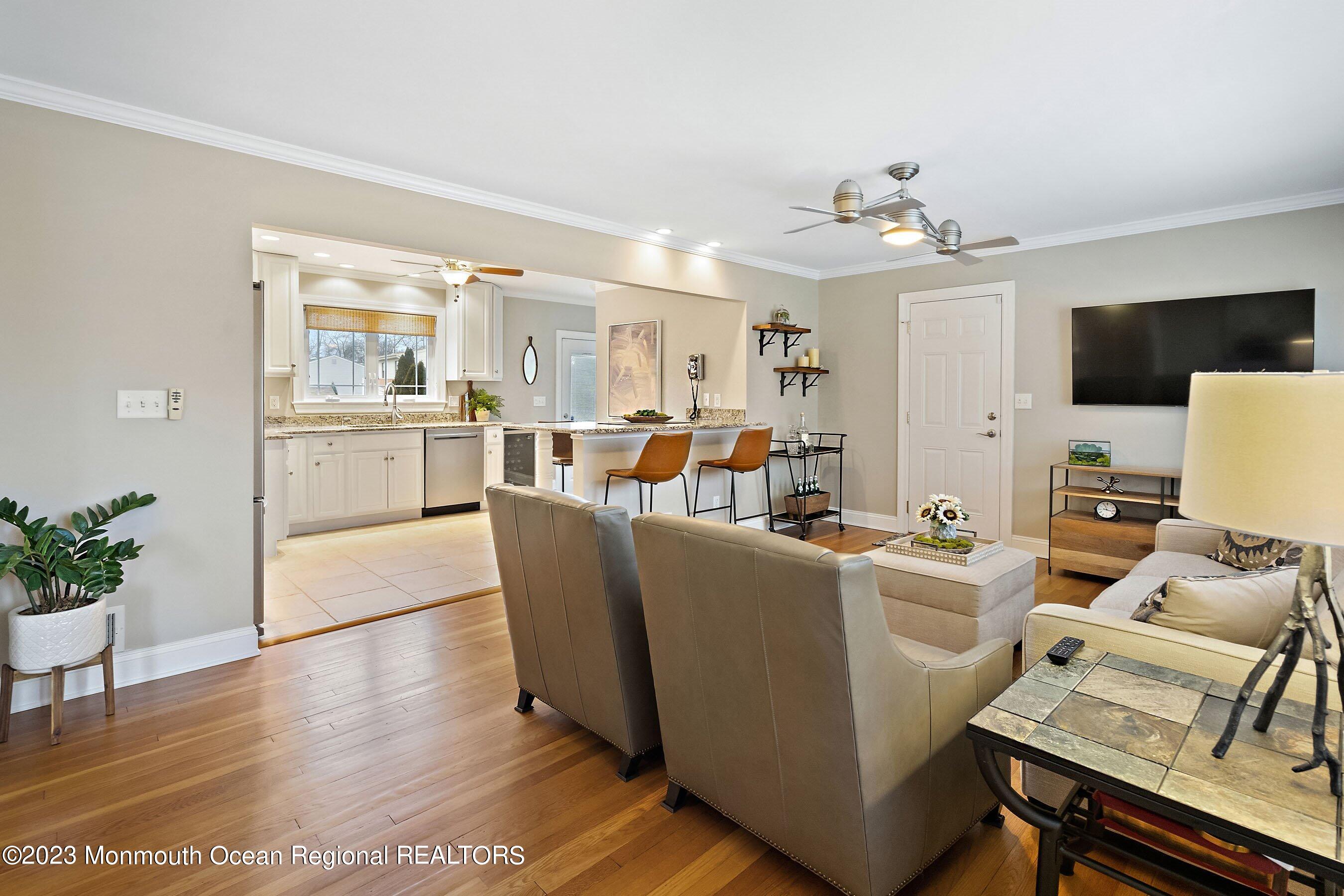 554 Hopping Road Belford, NJ 07718 - Photo 5 of 26 a living room with furniture a dining table and chairs with wooden floor