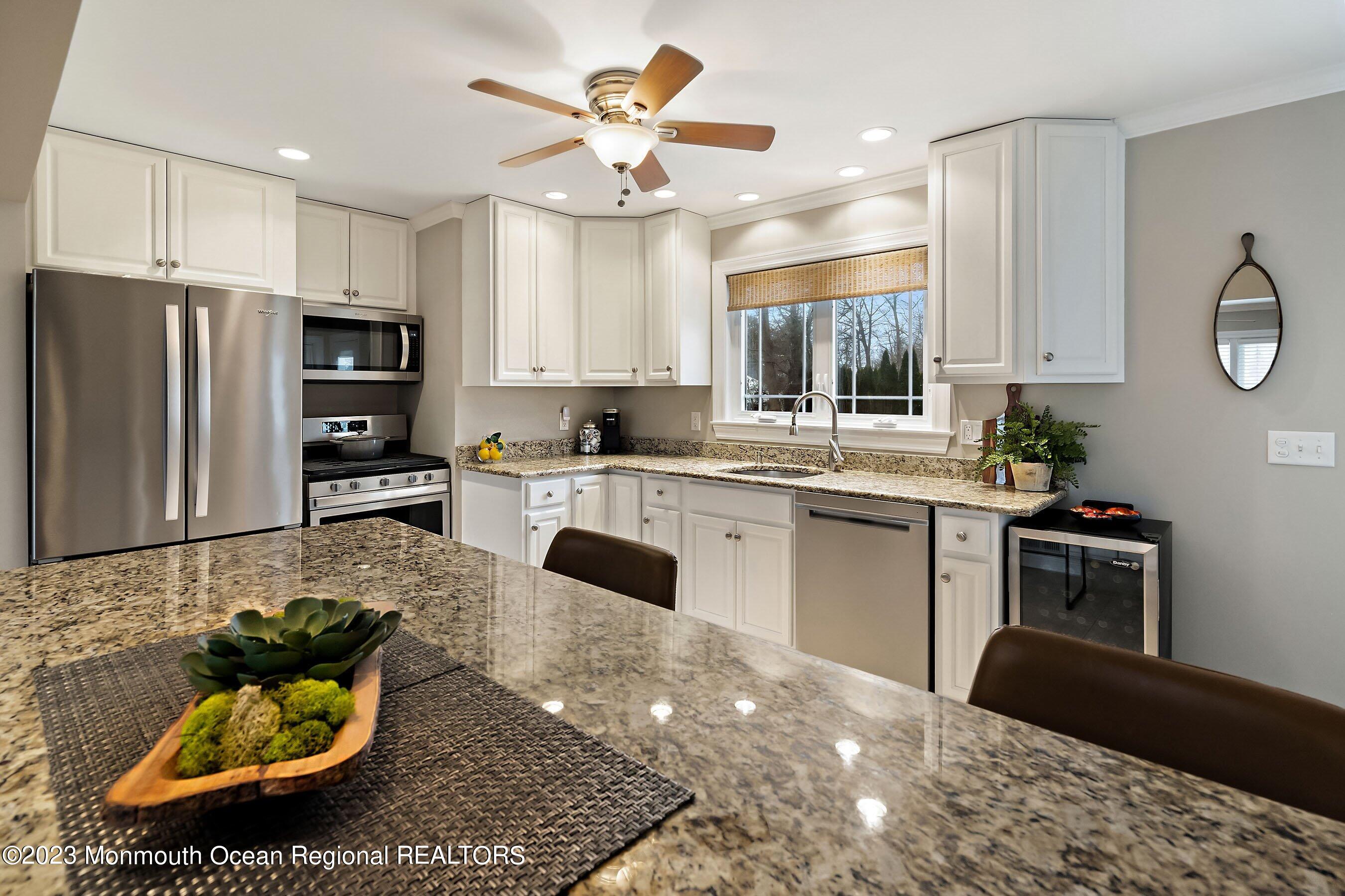 554 Hopping Road Belford, NJ 07718 - Photo 8 of 26 a kitchen with stainless steel appliances granite countertop a sink refrigerator stove and microwave