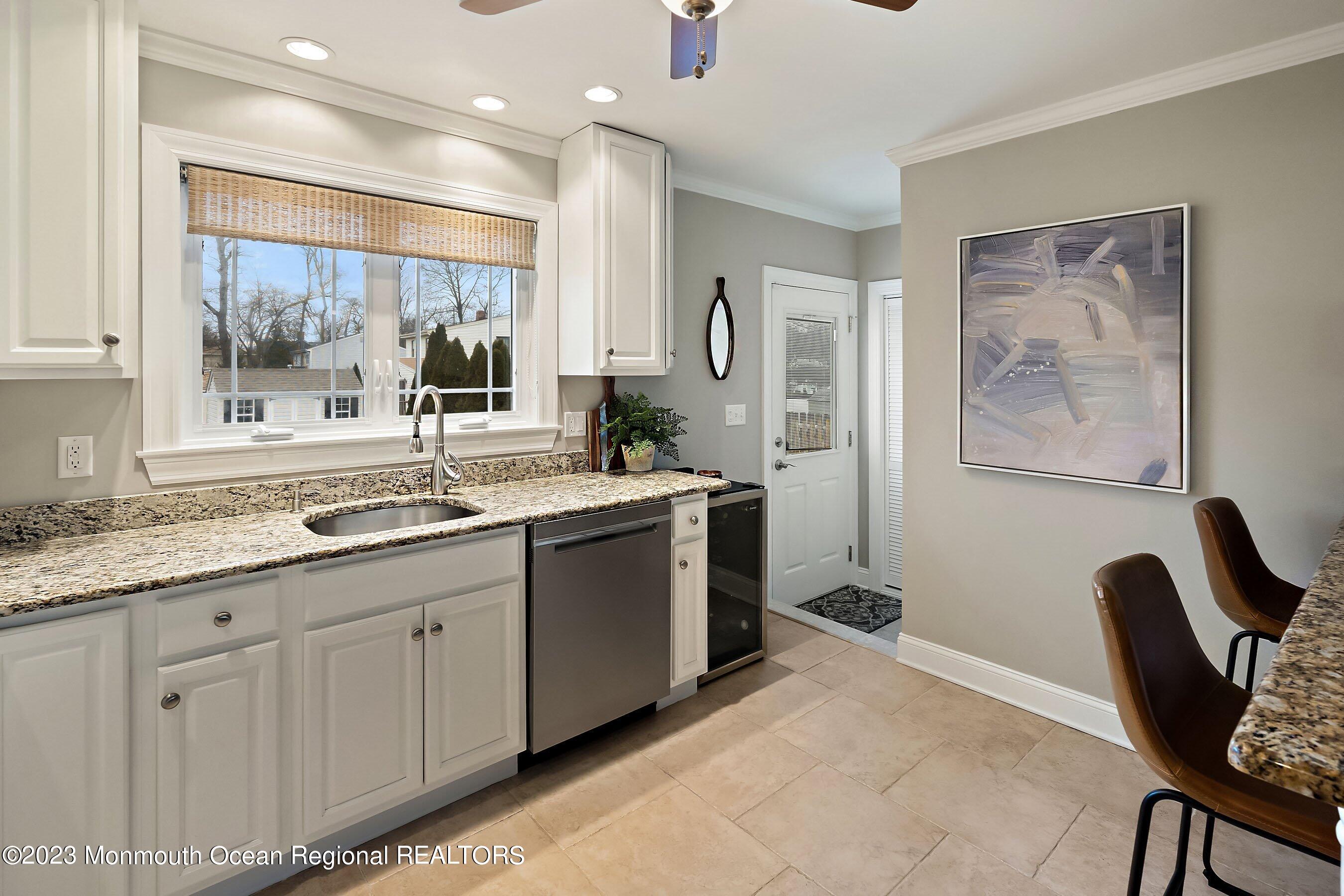 554 Hopping Road Belford, NJ 07718 - Photo 10 of 26 a large white kitchen with a large window