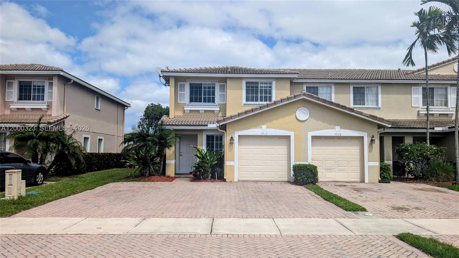 5910 Royal Way Tamarac, FL 33321 - Photo 1 of 36 a front view of a house with a yard and garage