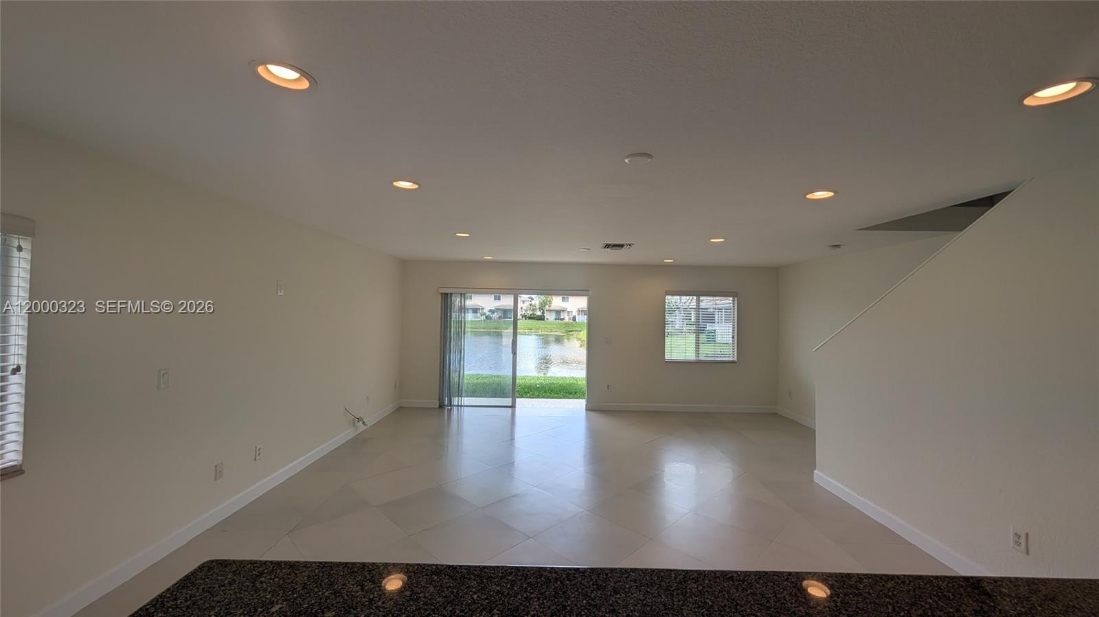 5910 Royal Way Tamarac, FL 33321 - Photo 15 of 36 an empty room with wooden floor and windows