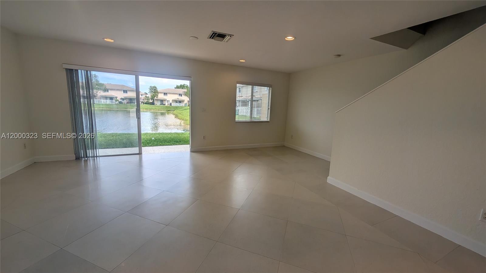 5910 Royal Way Tamarac, FL 33321 - Photo 16 of 36 an empty room with wooden floor and windows