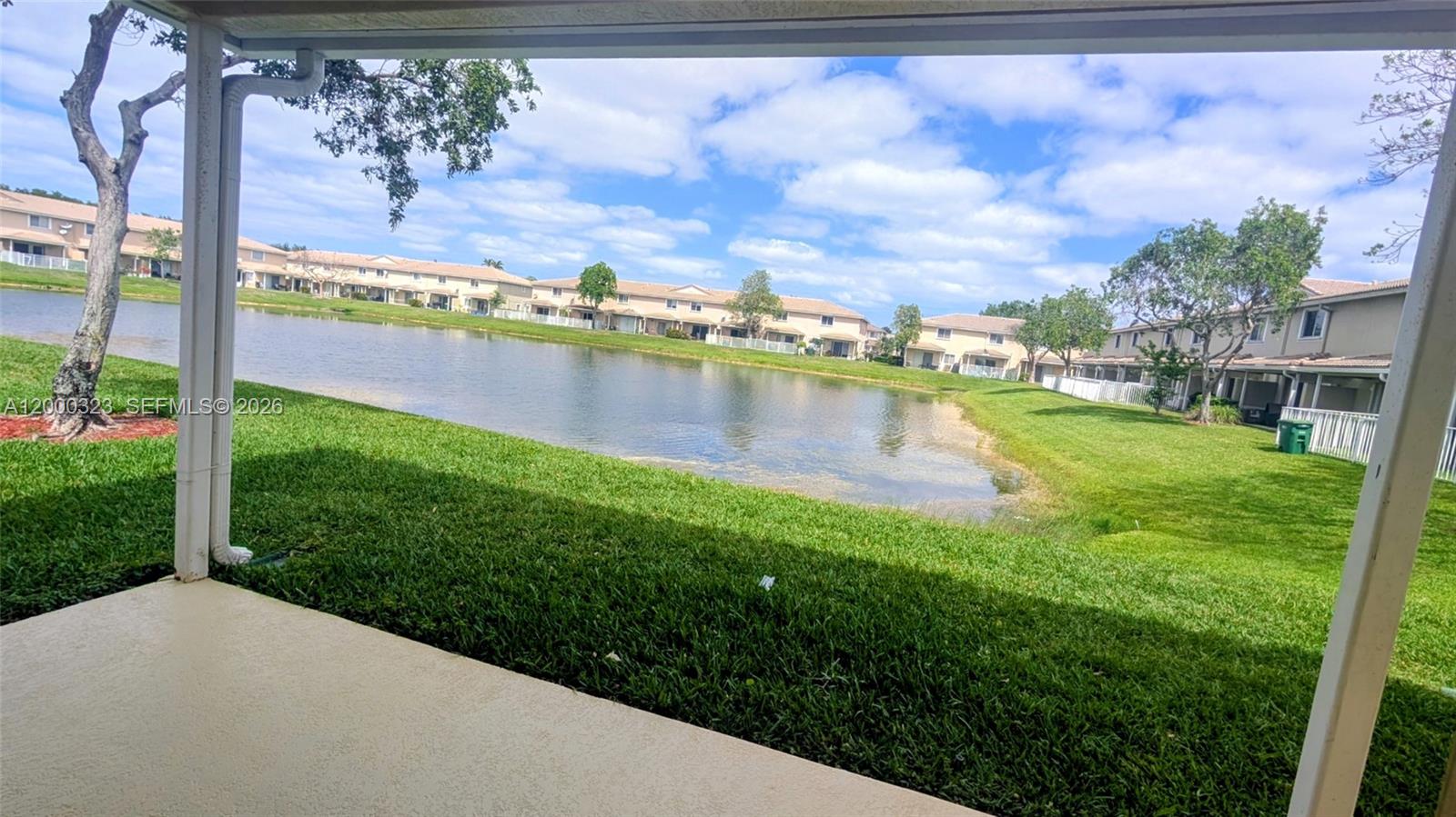 5910 Royal Way Tamarac, FL 33321 - Photo 18 of 36 a view of a lake with a yard