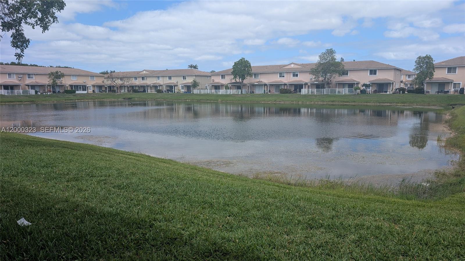 5910 Royal Way Tamarac, FL 33321 - Photo 2 of 36 a view of a lake with houses in the back