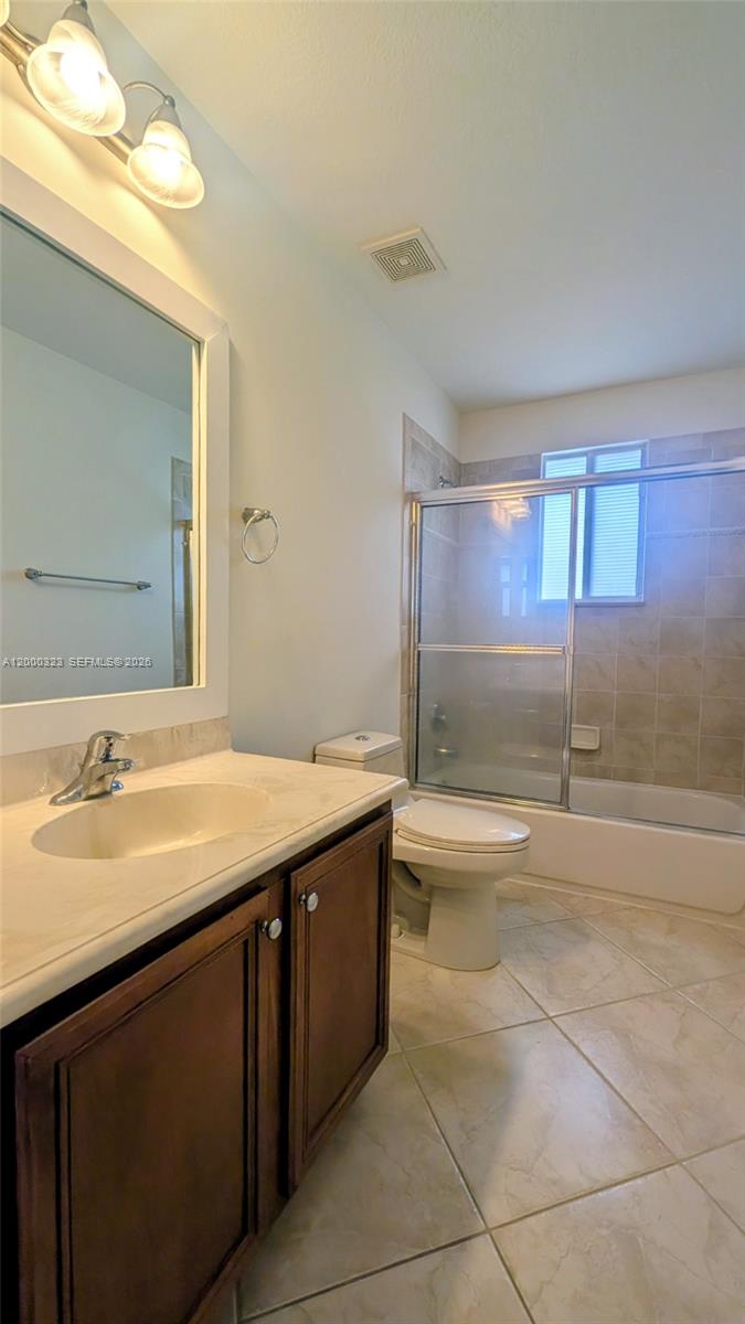 5910 Royal Way Tamarac, FL 33321 - Photo 24 of 36 a bathroom with a granite countertop sink and a mirror