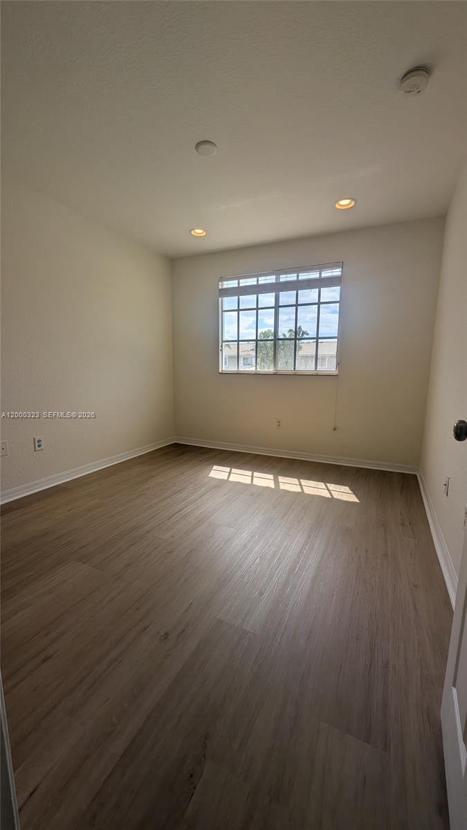 5910 Royal Way Tamarac, FL 33321 - Photo 25 of 36 an empty room with wooden floor and windows