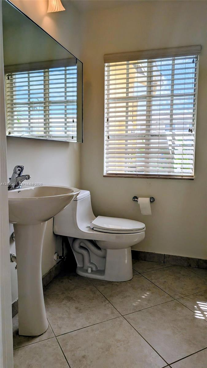 5910 Royal Way Tamarac, FL 33321 - Photo 29 of 36 a bathroom with a sink and a toilet