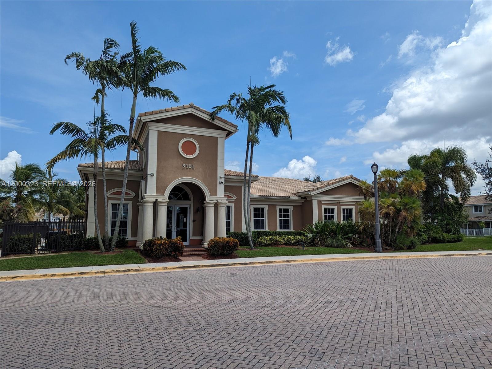 5910 Royal Way Tamarac, FL 33321 - Photo 32 of 36 a view of a building with a yard and palm trees