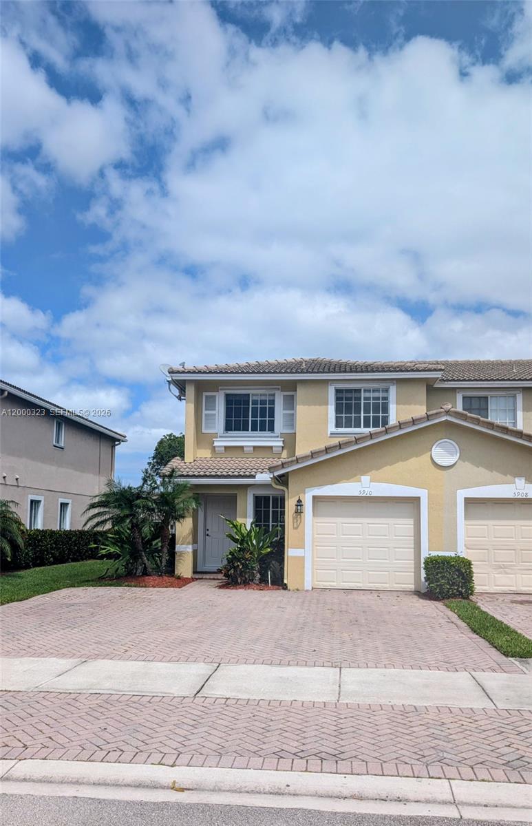 5910 Royal Way Tamarac, FL 33321 - Photo 36 of 36 a front view of a house with a yard and garage
