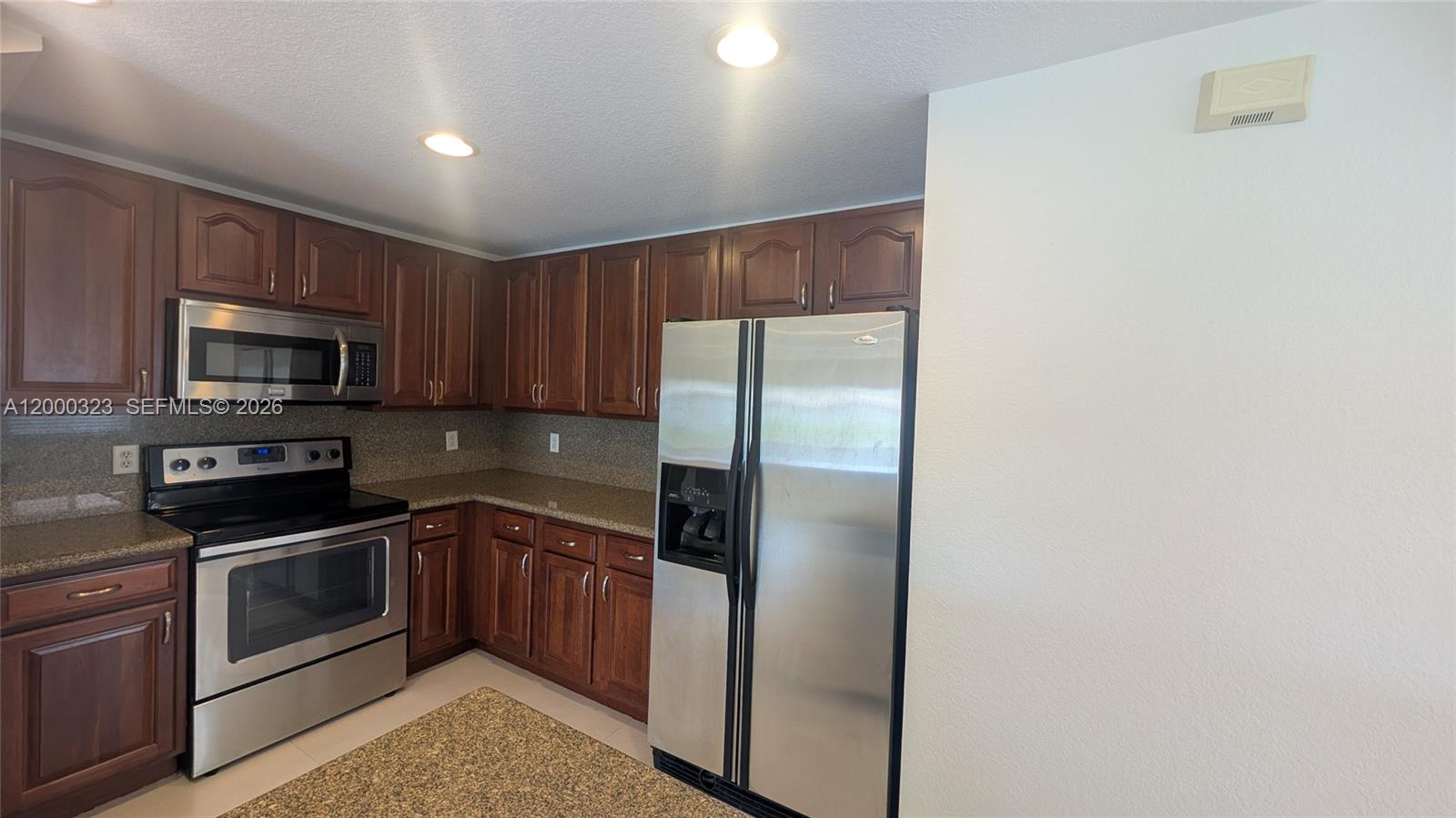 5910 Royal Way Tamarac, FL 33321 - Photo 4 of 36 a kitchen with a refrigerator sink and microwave