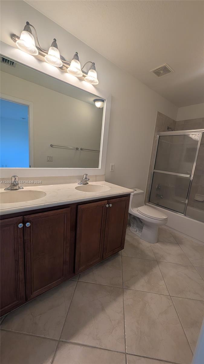 5910 Royal Way Tamarac, FL 33321 - Photo 6 of 36 a bathroom with a sink vanity and mirror