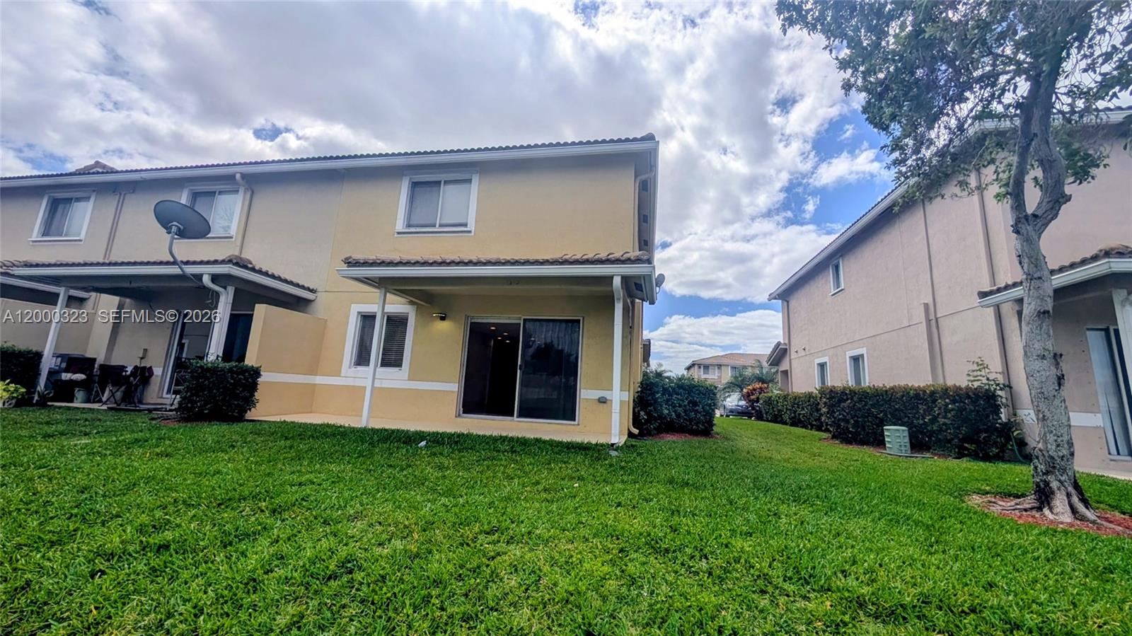 5910 Royal Way Tamarac, FL 33321 - Photo 8 of 36 a front view of a house with a yard and garage