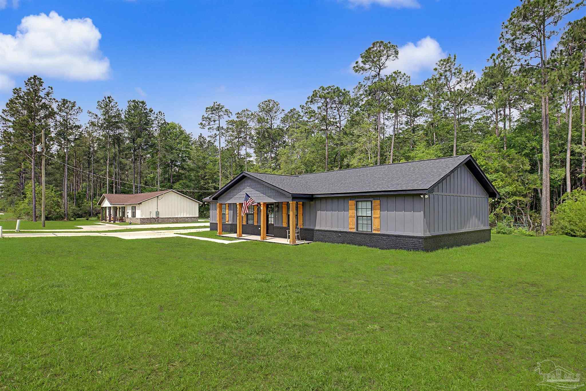 2549 Ten Mile Road Pace, FL 32571 - Photo 37 of 46 a front view of a house with a yard