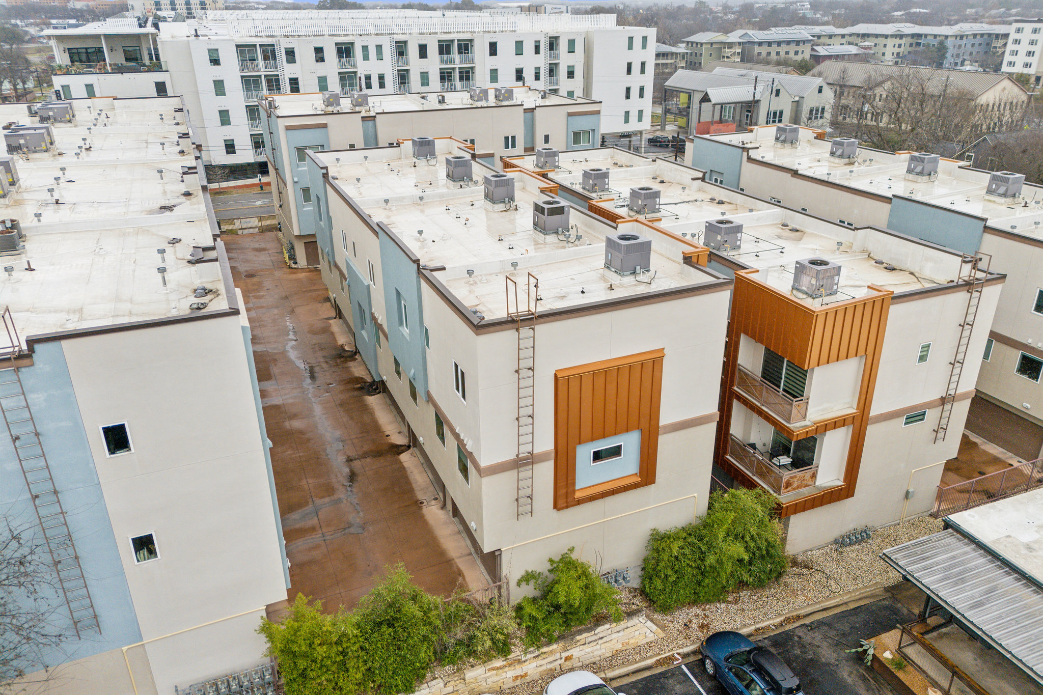 2827 Manor Road, Unit 3104 Austin, TX 78722 - Photo 24 of 30 An aerial perspective reveals contemporary multi-level townhomes with sleek lines and integrated balconies.
