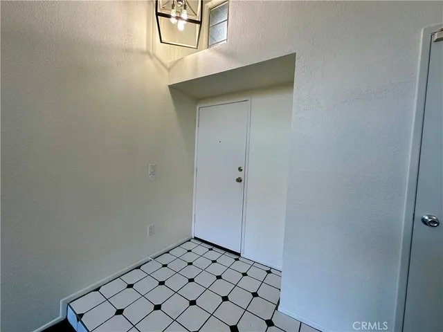 a view of an entryway door and garden